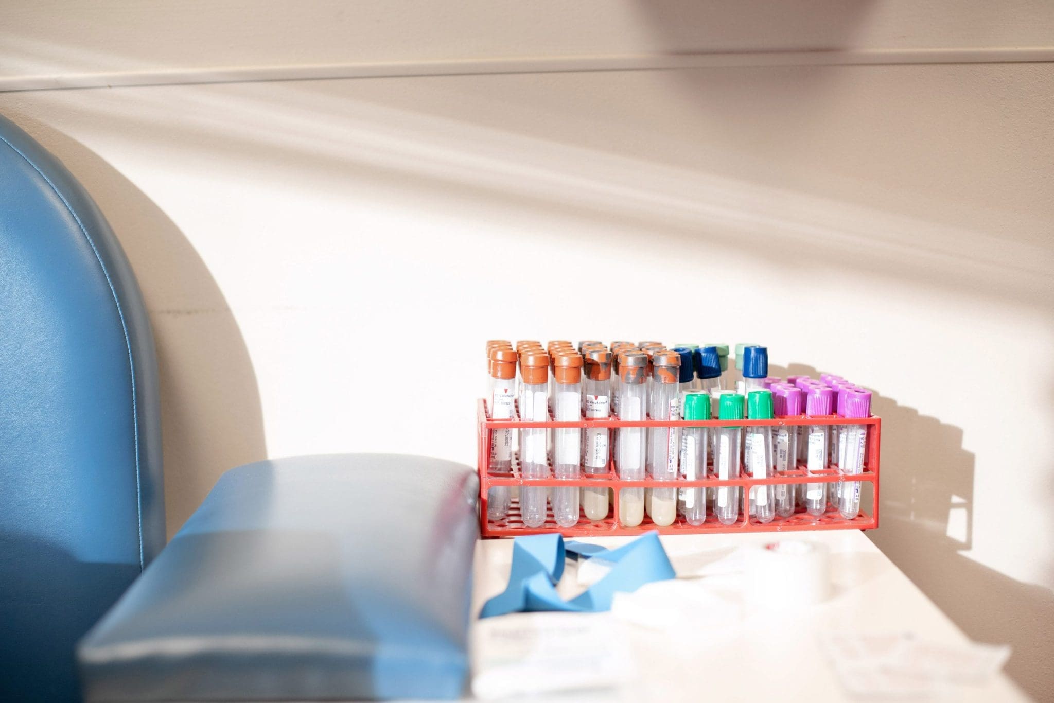 Close-up of vials of blood labeled for medical testing in a healthcare clinic.